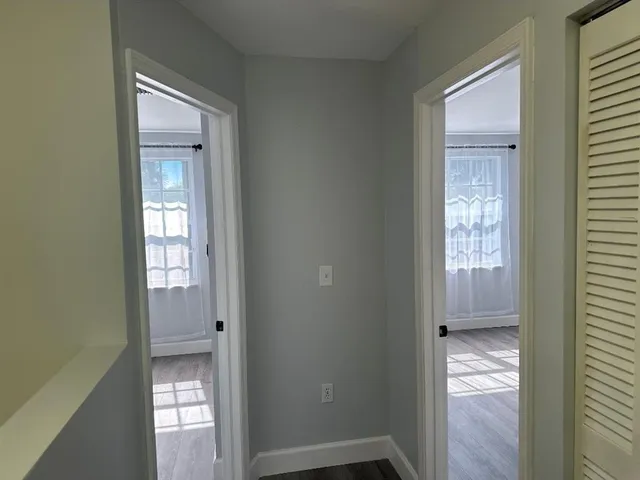 a view of a room with wooden floor