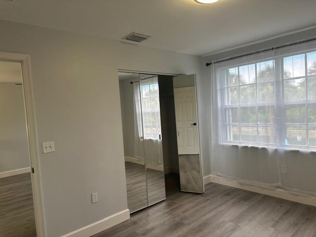 4151 Eastridge Circle Deerfield Beach, FL 33064 - Photo 41 of 53 an empty room with wooden floor and windows