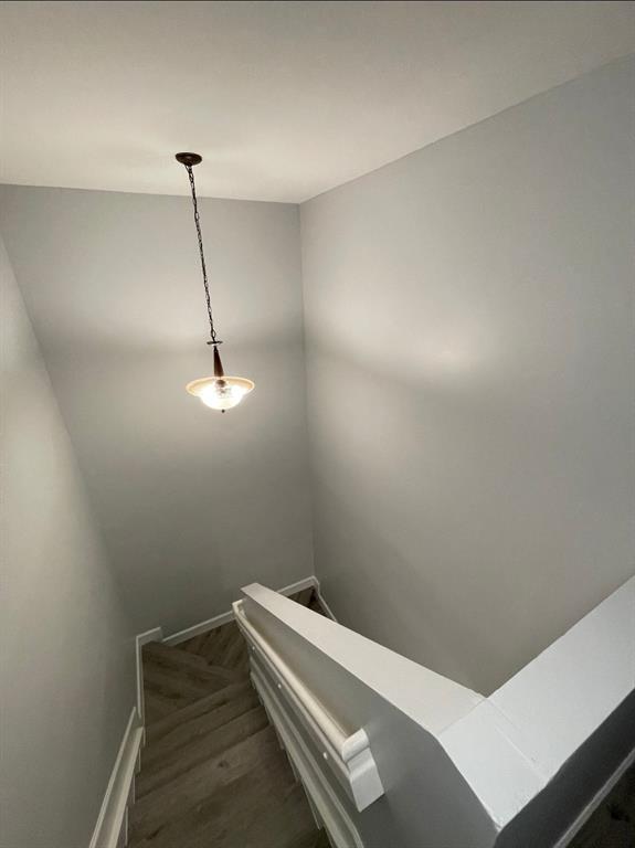 4151 Eastridge Circle Deerfield Beach, FL 33064 - Photo 44 of 53 a view of a room with a hanging light and hardwood