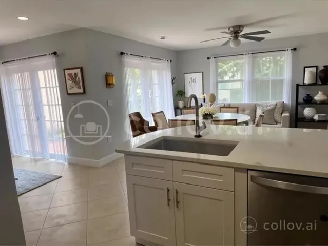 a kitchen with a sink cabinets and window