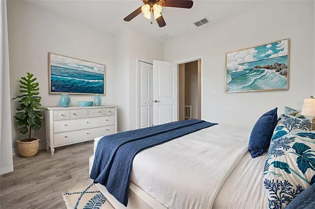 a bedroom with a bed and a painting on the wall