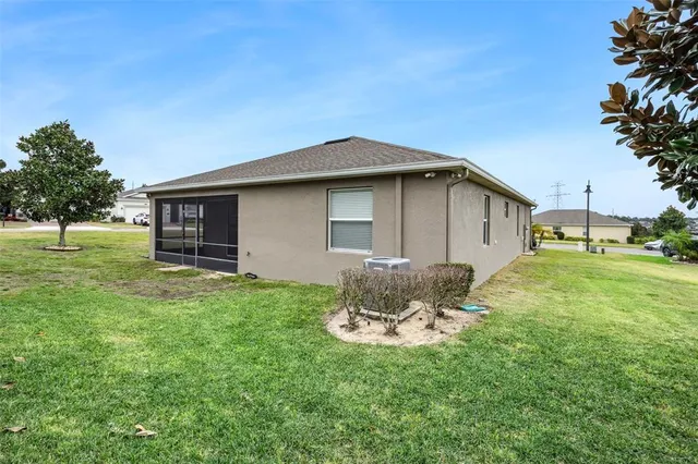 a backyard of a house with table and chairs