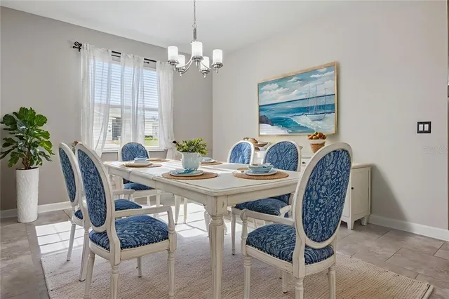 a view of a dining room with furniture and chandelier