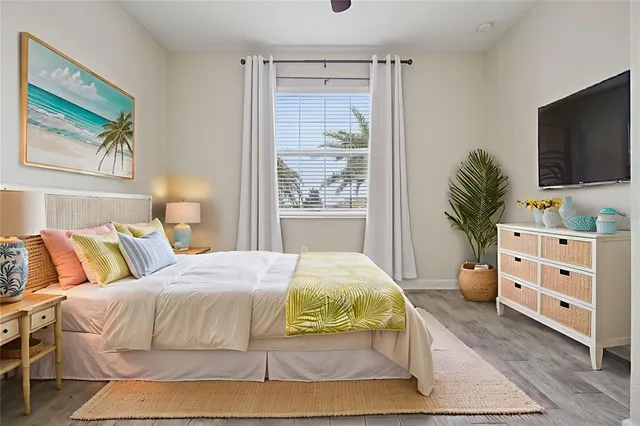 a bedroom with a bed and a flat screen television