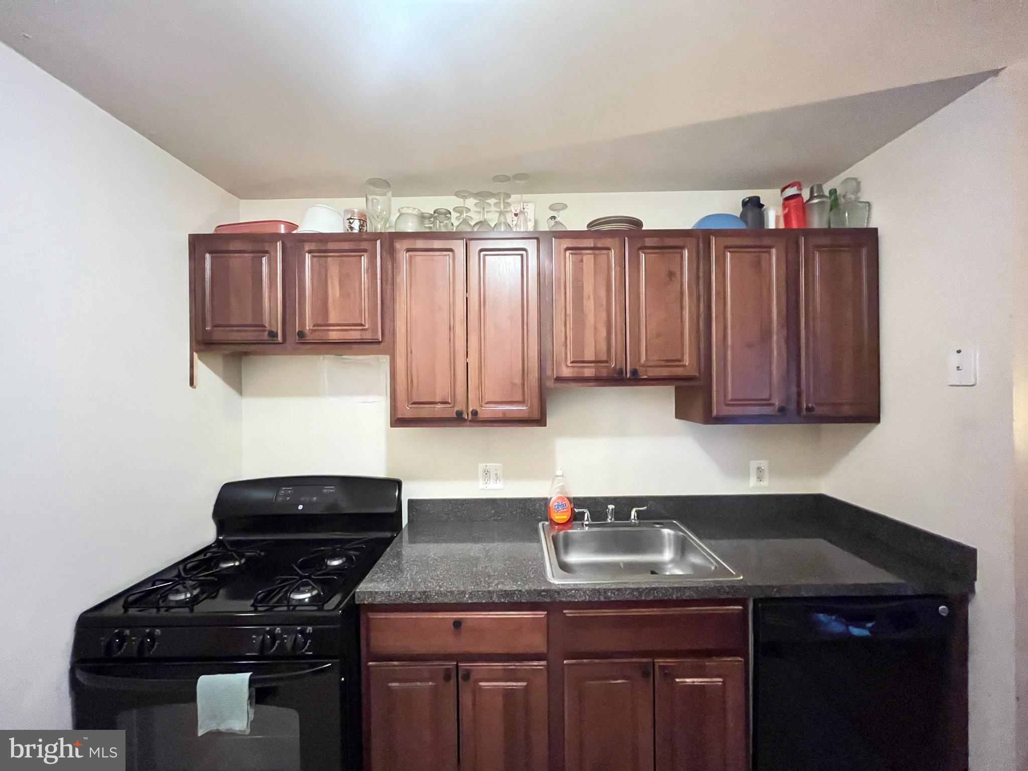 7101 Donnell Place, Unit D8 District Heights, MD 20747 - Photo 13 of 35 a kitchen with a sink a stove and cabinets