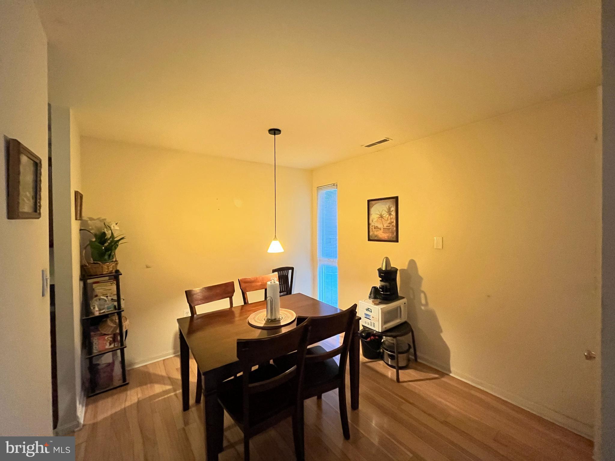 7101 Donnell Place, Unit D8 District Heights, MD 20747 - Photo 14 of 35 a view of a dining room with furniture and wooden floor