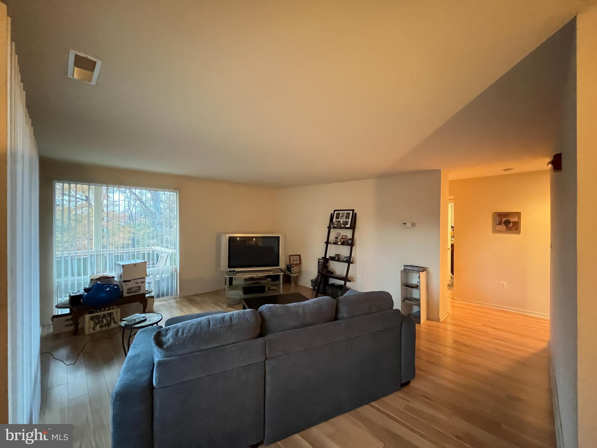 7101 Donnell Place, Unit D8 District Heights, MD 20747 - Photo 16 of 35 a living room with furniture a flat screen tv and floor to ceiling window
