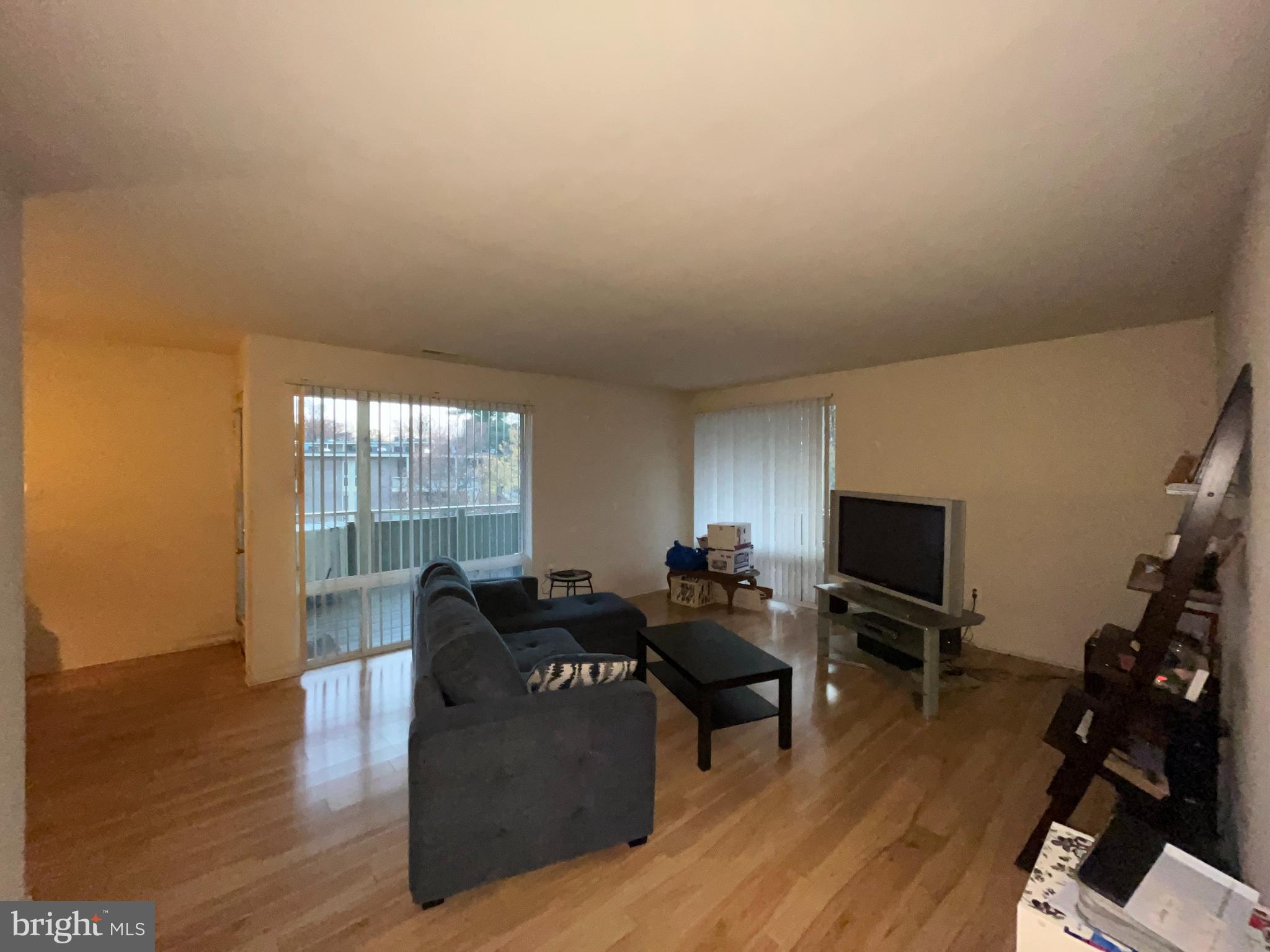 7101 Donnell Place, Unit D8 District Heights, MD 20747 - Photo 17 of 35 a living room with furniture a flat screen tv and a window