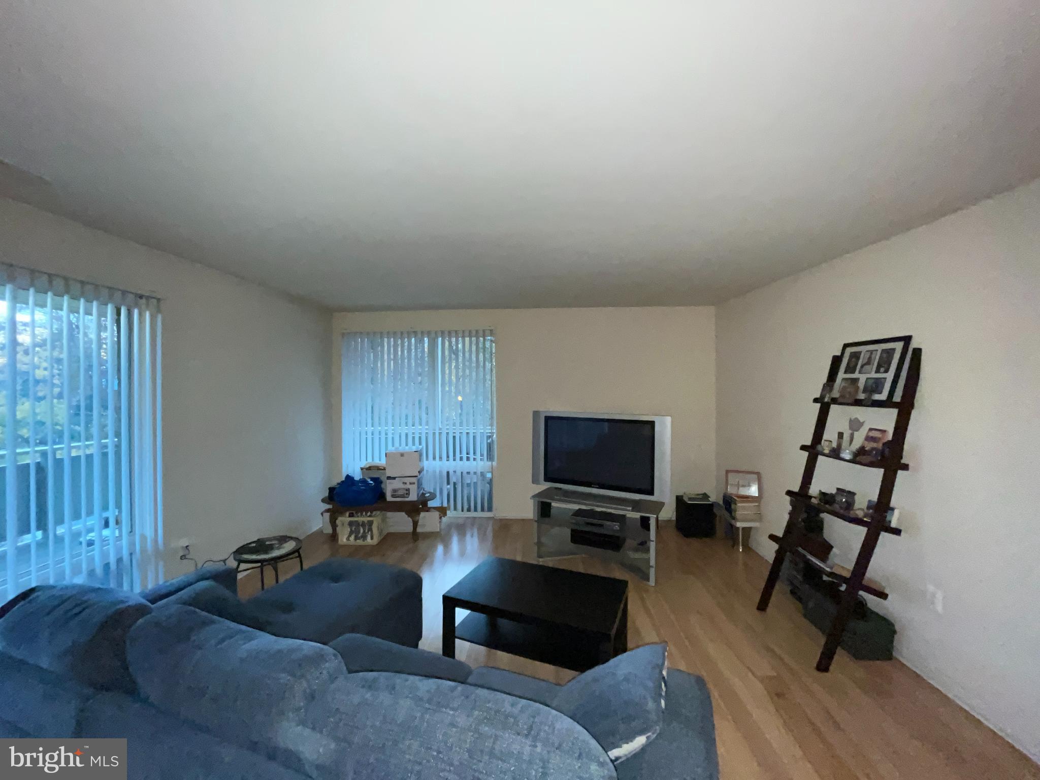 7101 Donnell Place, Unit D8 District Heights, MD 20747 - Photo 18 of 35 a living room with furniture a rug and a flat screen tv