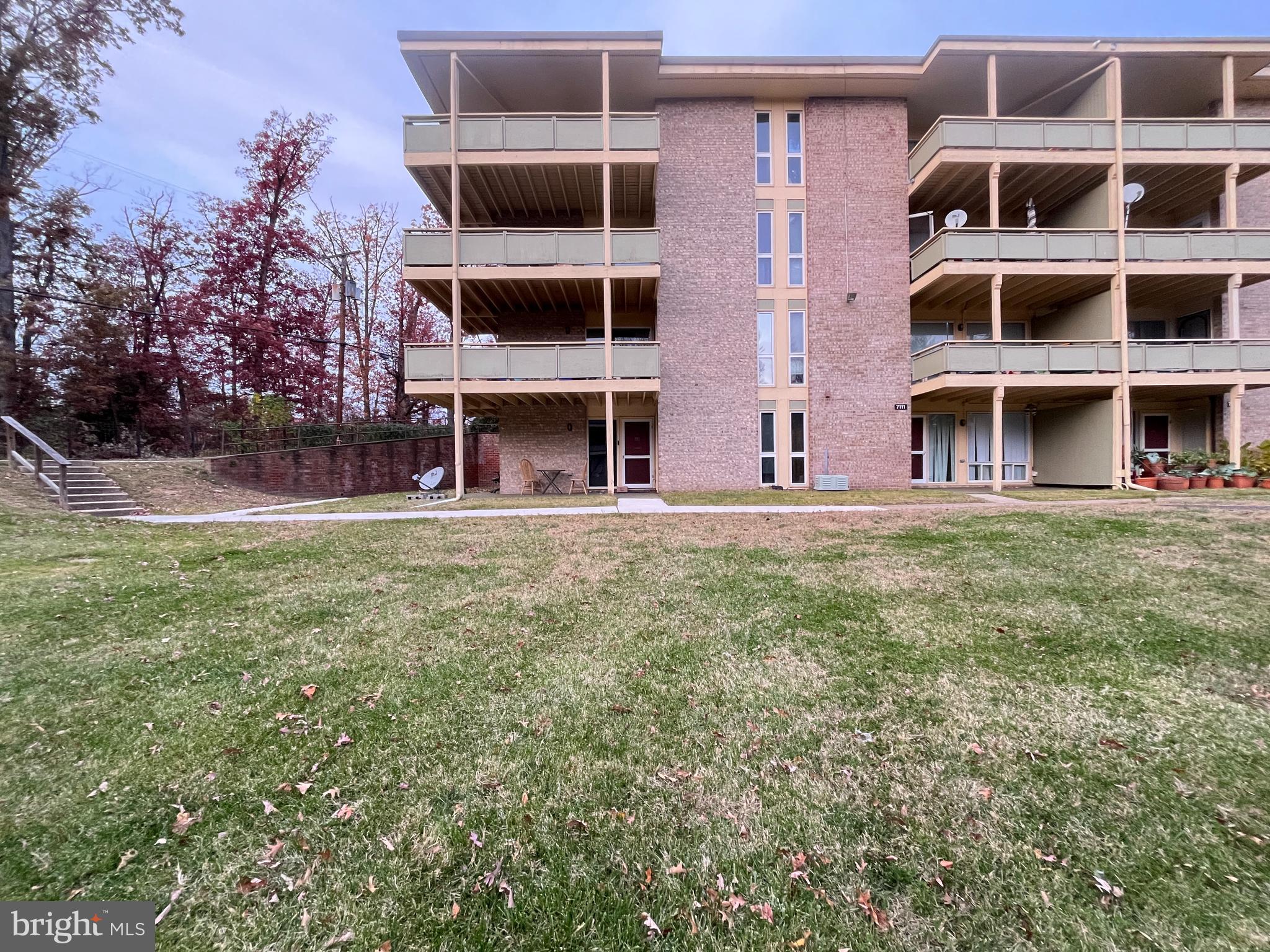 7101 Donnell Place, Unit D8 District Heights, MD 20747 - Photo 2 of 35 a view of a building with a yard