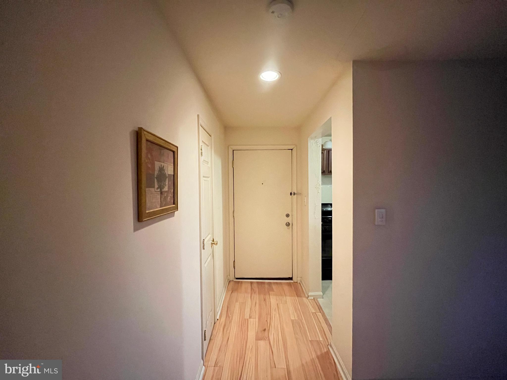 7101 Donnell Place, Unit D8 District Heights, MD 20747 - Photo 24 of 35 a view of a hallway with wooden floor and a bathroom