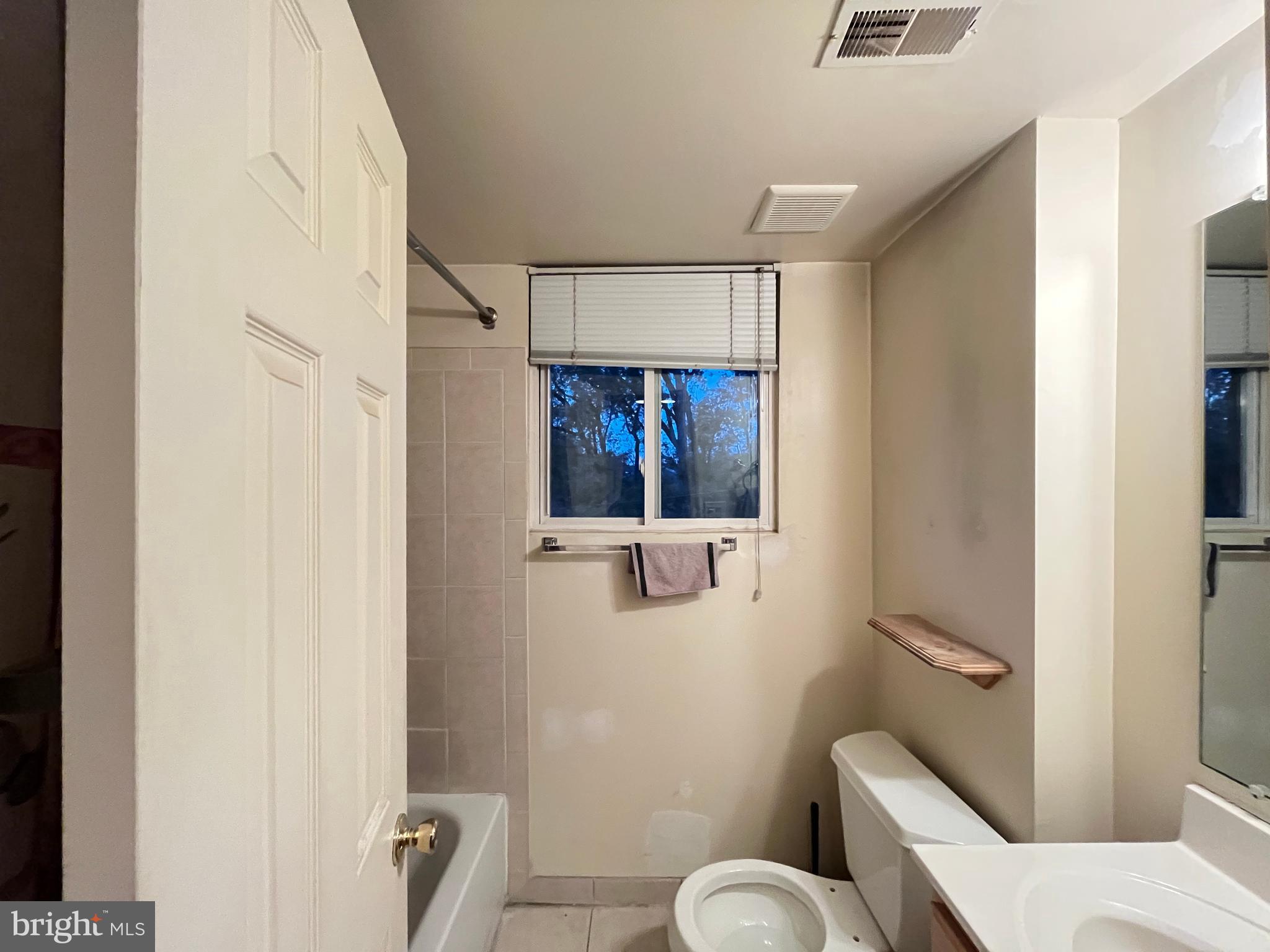 7101 Donnell Place, Unit D8 District Heights, MD 20747 - Photo 28 of 35 a bathroom with a toilet sink and shower curtain
