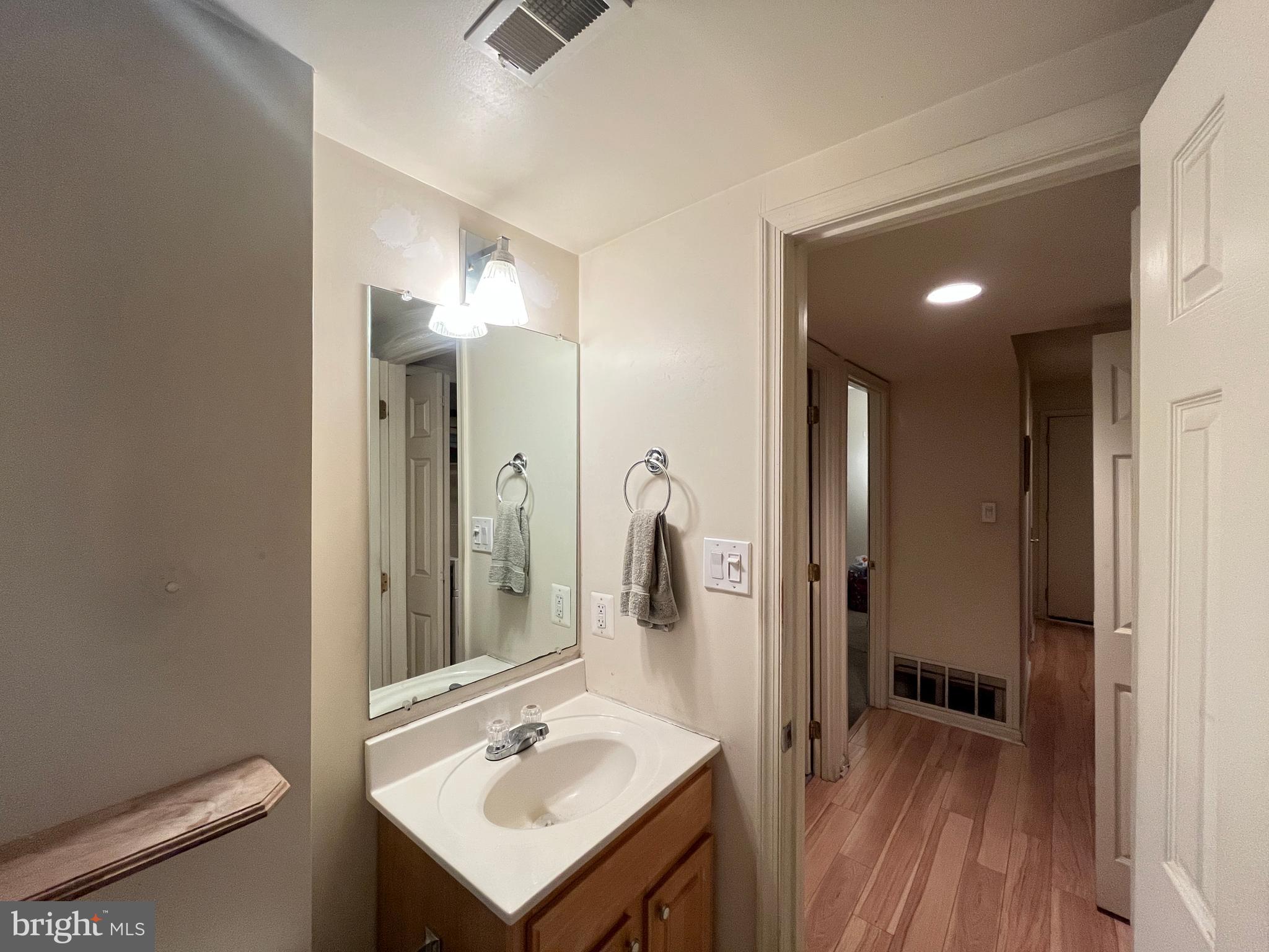 7101 Donnell Place, Unit D8 District Heights, MD 20747 - Photo 31 of 35 a bathroom with a sink a toilet a mirror and shower