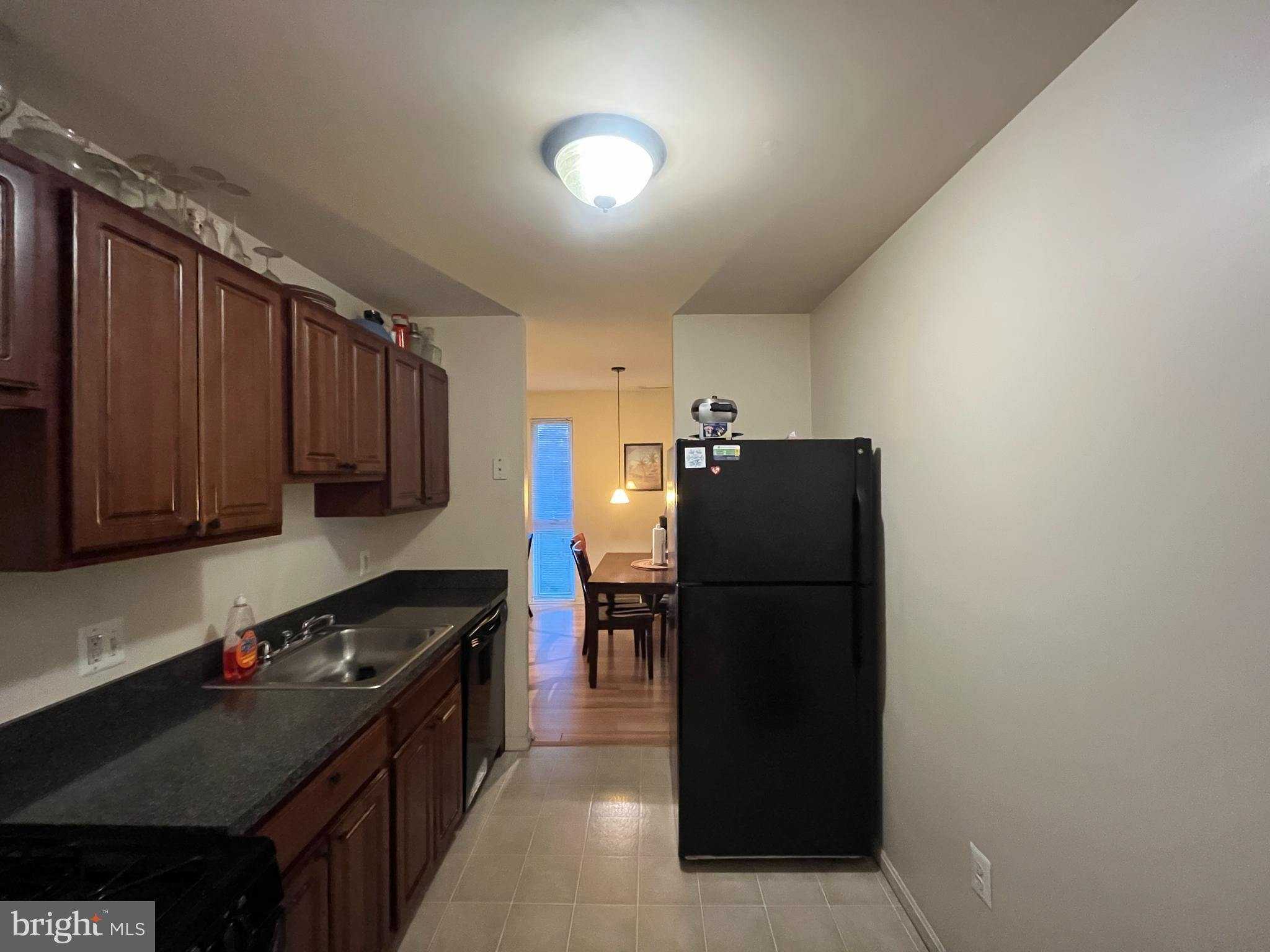 7101 Donnell Place, Unit D8 District Heights, MD 20747 - Photo 10 of 35 a kitchen with stainless steel appliances granite countertop a refrigerator and a stove top oven