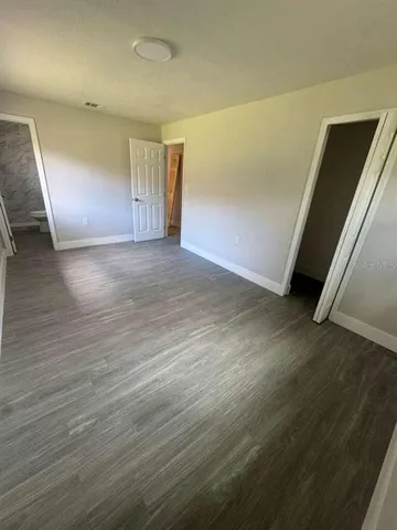 an empty room with wooden floor