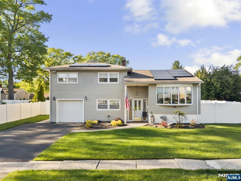 62 Sycamore Road Dumont, NJ 07628 - Photo 39 of 43 a front view of a house with a garden and plants