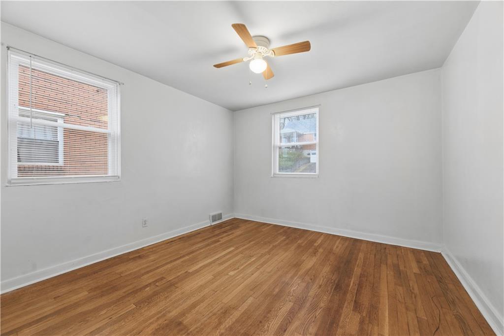 614 Ridgemont Drive Pittsburgh, PA 15220 - Photo 11 of 26 a view of an empty room with wooden floor and a window