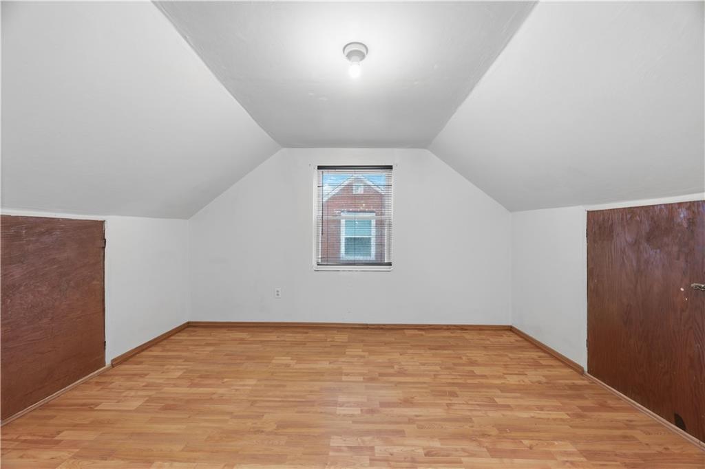 614 Ridgemont Drive Pittsburgh, PA 15220 - Photo 16 of 26 an empty room with wooden floor and window