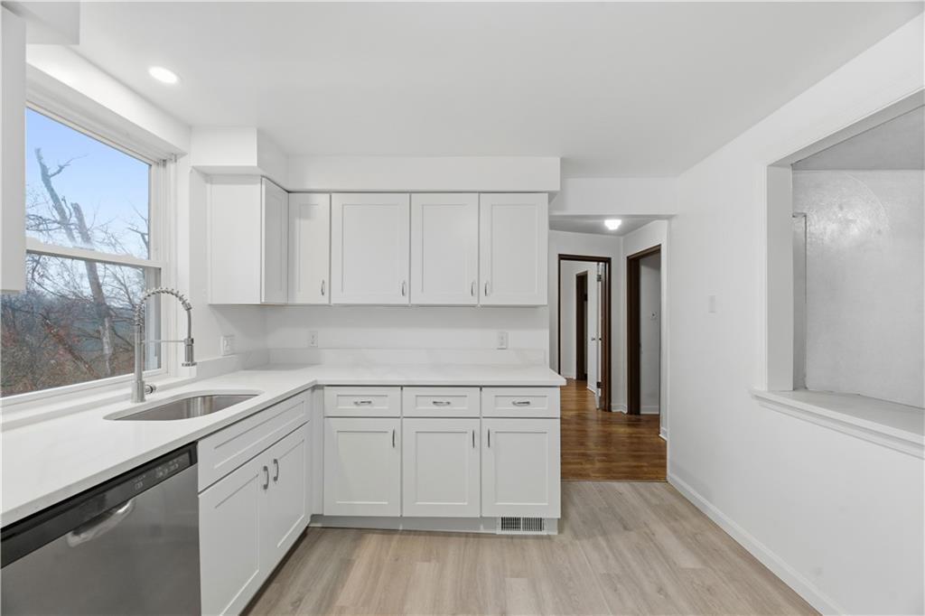 614 Ridgemont Drive Pittsburgh, PA 15220 - Photo 7 of 26 a kitchen with a sink cabinets stainless steel appliances and a window