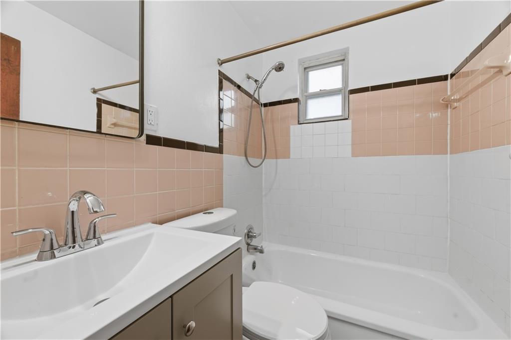 614 Ridgemont Drive Pittsburgh, PA 15220 - Photo 8 of 26 a bathroom with a sink a toilet and shower