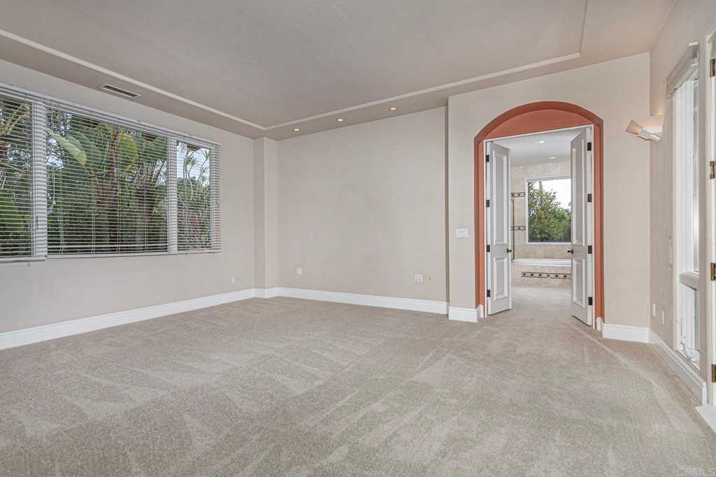 6944 Rancho Cielo Rancho Santa Fe, CA 92067 - Photo 16 of 37 a view of an empty room with window and a kitchen