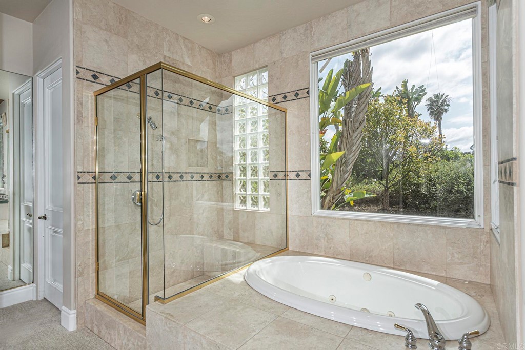 6944 Rancho Cielo Rancho Santa Fe, CA 92067 - Photo 18 of 37 a bathroom with a bathtub and shower