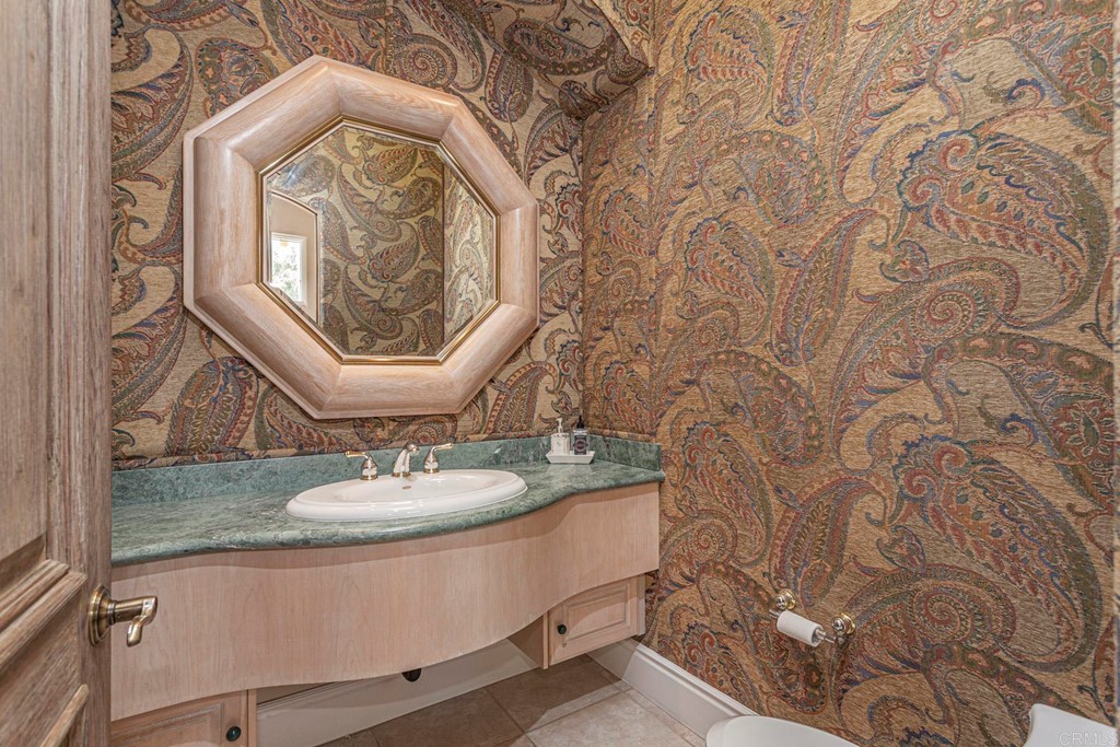 6944 Rancho Cielo Rancho Santa Fe, CA 92067 - Photo 21 of 37 a bathroom with a granite countertop sink and a mirror