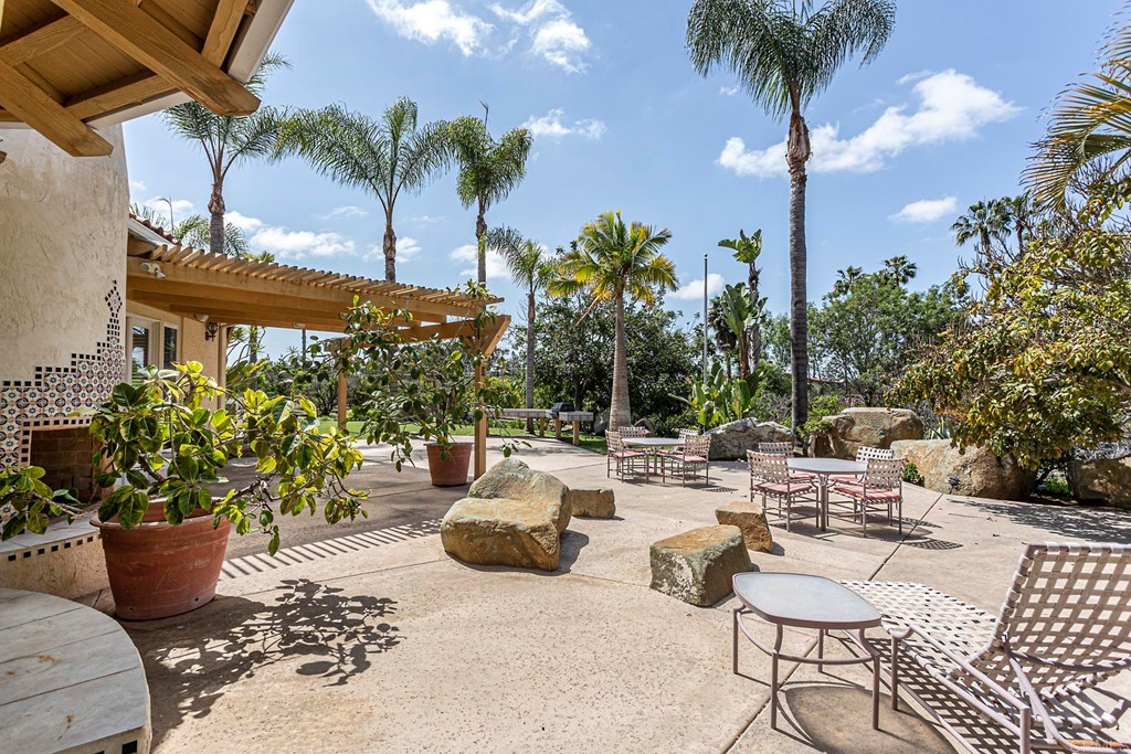 6944 Rancho Cielo Rancho Santa Fe, CA 92067 - Photo 26 of 37 a view of a patio with couches and potted plants