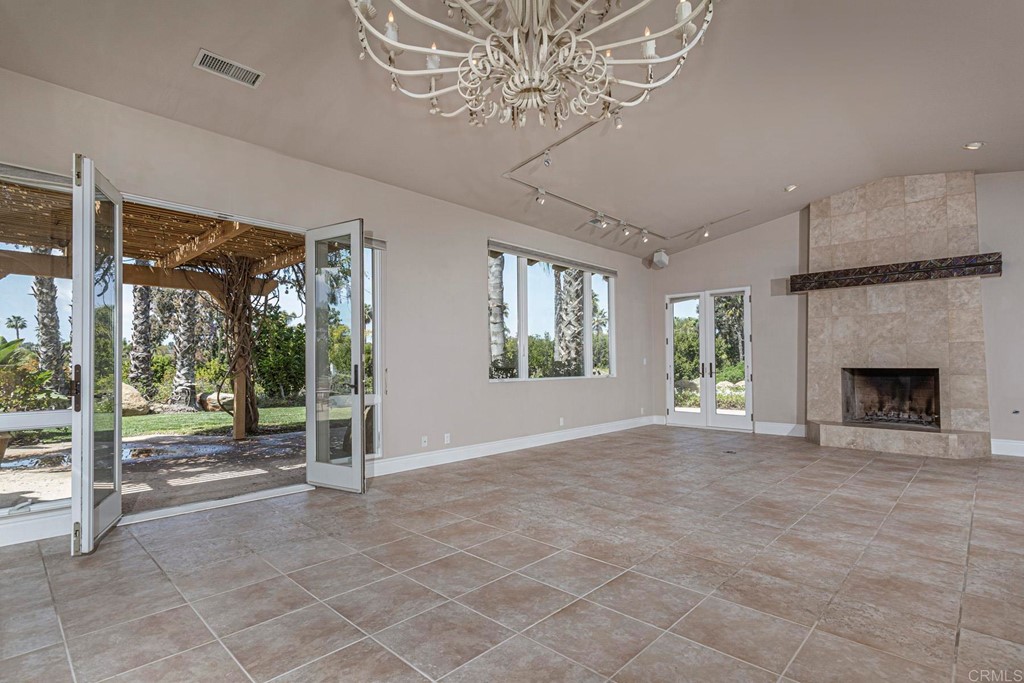 6944 Rancho Cielo Rancho Santa Fe, CA 92067 - Photo 3 of 37 a view of a livingroom with a fireplace and window