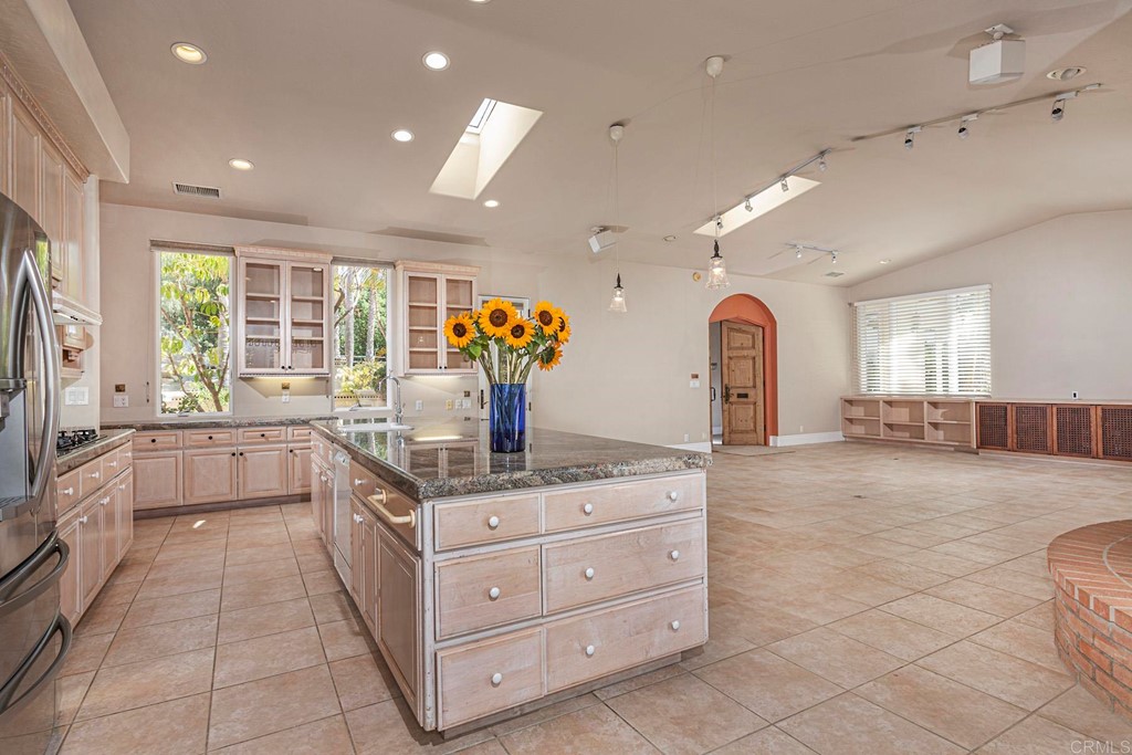 6944 Rancho Cielo Rancho Santa Fe, CA 92067 - Photo 6 of 37 a spacious bathroom with a granite countertop sink a mirror and a bathtub