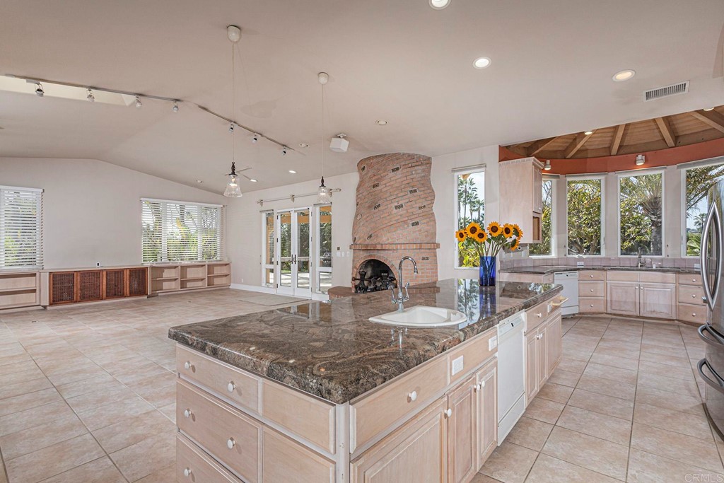 6944 Rancho Cielo Rancho Santa Fe, CA 92067 - Photo 10 of 37 a kitchen with stainless steel appliances granite countertop a sink and a white cabinets