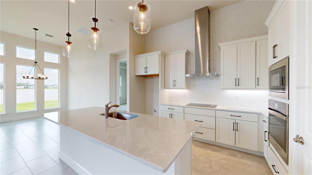 247 Azure Mist Way Daytona Beach, FL 32124 - Photo 11 of 40 a kitchen with white cabinets and refrigerator