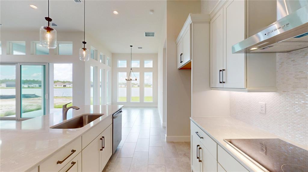 247 Azure Mist Way Daytona Beach, FL 32124 - Photo 12 of 40 a kitchen with granite countertop a sink a counter top space and stainless steel appliances