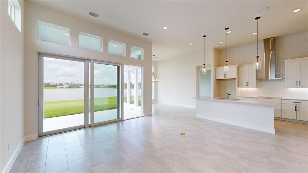 247 Azure Mist Way Daytona Beach, FL 32124 - Photo 17 of 40 a open kitchen with white cabinets and a large window