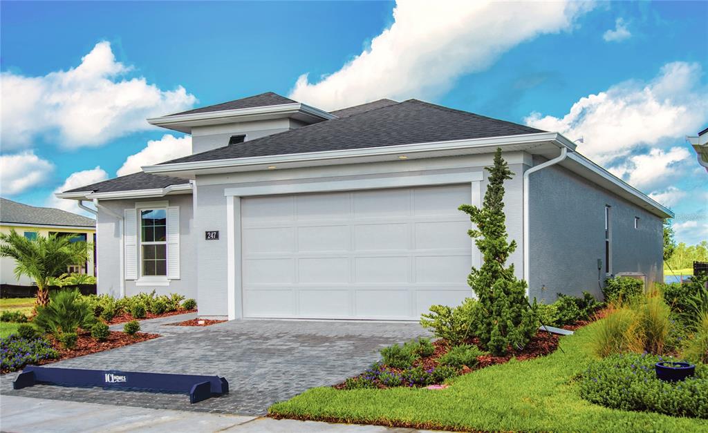 247 Azure Mist Way Daytona Beach, FL 32124 - Photo 3 of 40 a front view of a house with garden