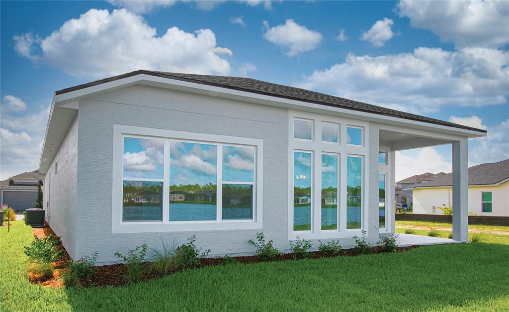 247 Azure Mist Way Daytona Beach, FL 32124 - Photo 32 of 40 a front view of a house with a yard and plants