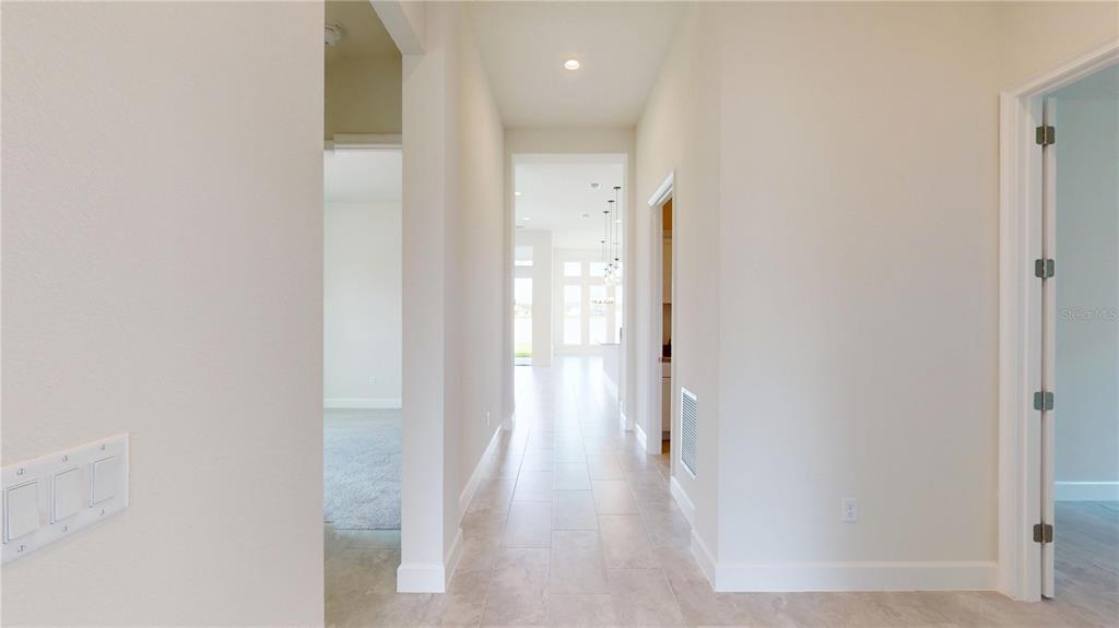 247 Azure Mist Way Daytona Beach, FL 32124 - Photo 4 of 40 a view of a hallway with wooden floor