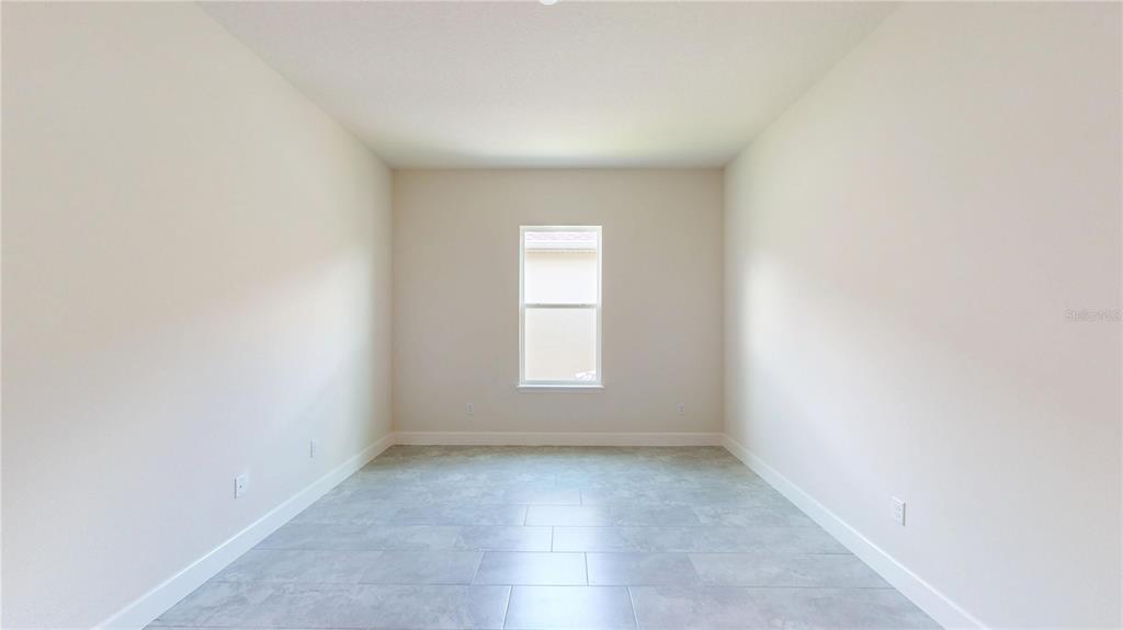 247 Azure Mist Way Daytona Beach, FL 32124 - Photo 5 of 40 an empty room with a window