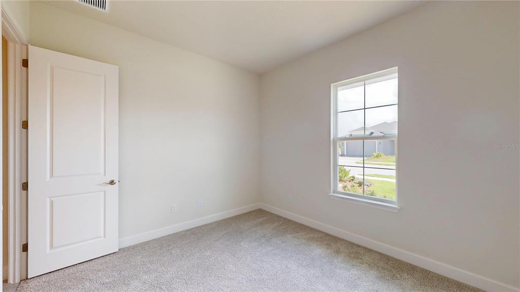 247 Azure Mist Way Daytona Beach, FL 32124 - Photo 8 of 40 an empty room with a window