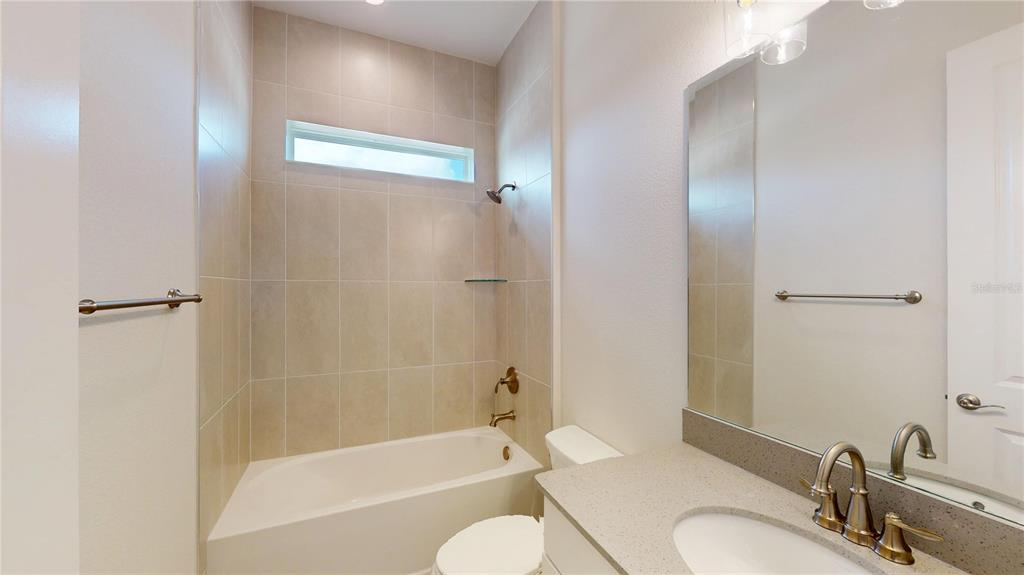 247 Azure Mist Way Daytona Beach, FL 32124 - Photo 10 of 40 a bathroom with a granite countertop sink toilet and shower