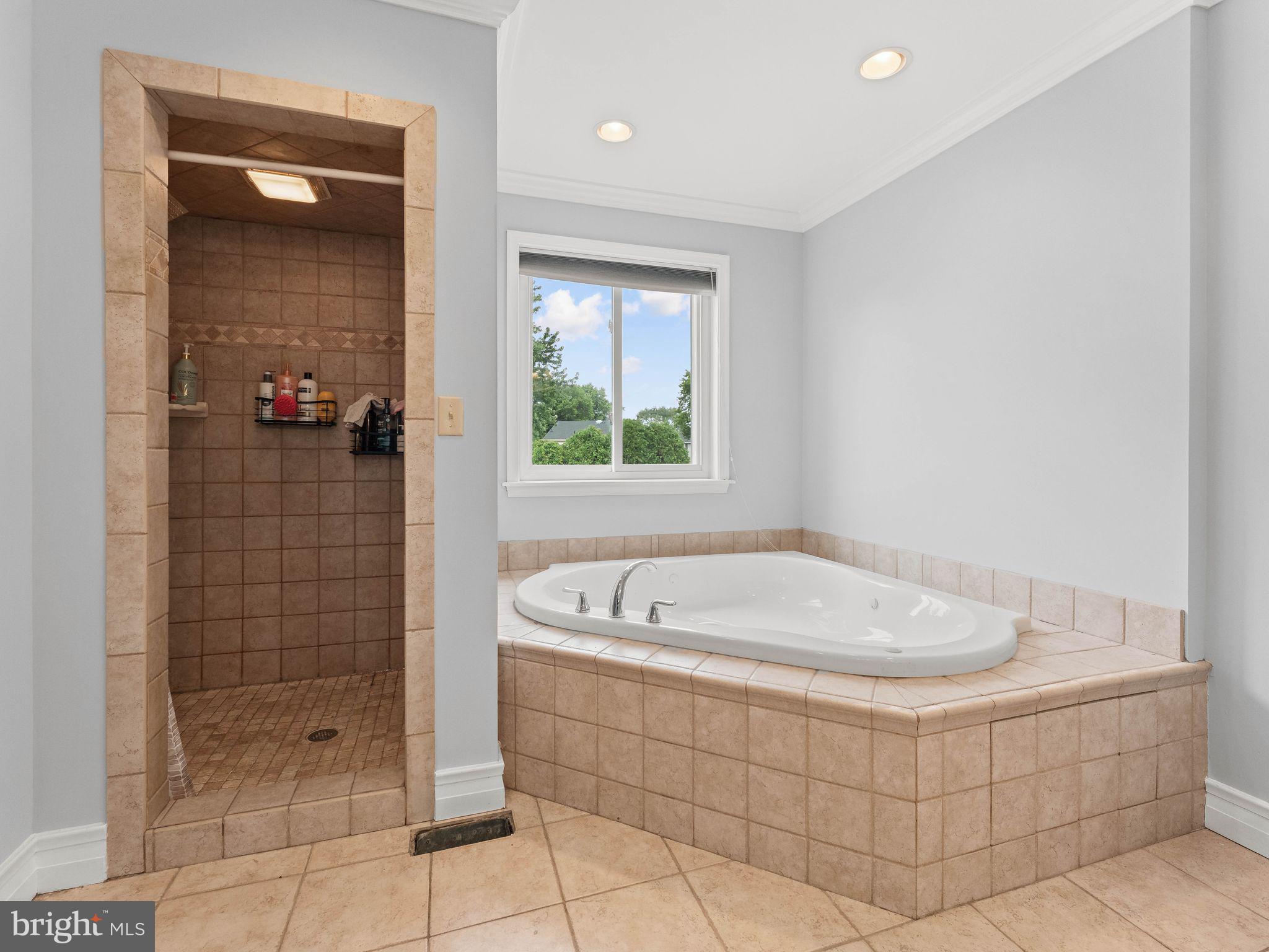 8 Chesterfield Road Sewell, NJ 08080 - Photo 27 of 57 a bathroom with a tub a window and a shower