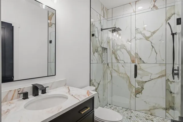 a bathroom with a sink toilet and shower