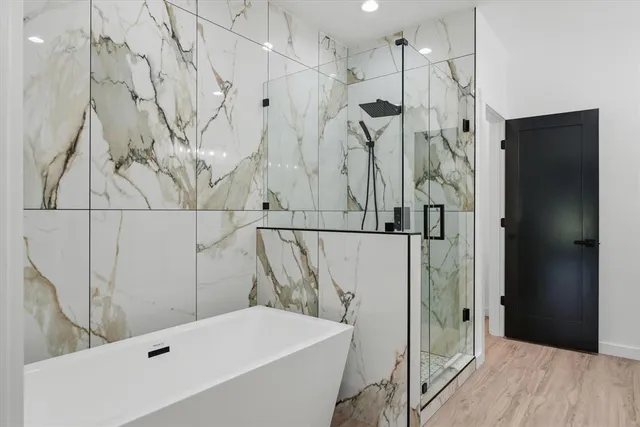 a bathroom with a bathtub and a shower