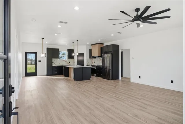 a view of a kitchen with a sink and stainless steel appliances