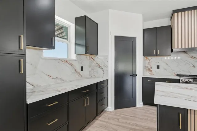 a kitchen with stainless steel appliances granite countertop a refrigerator and a sink