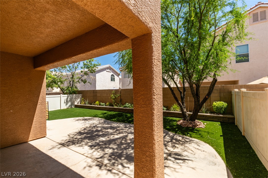 8909 Houston Ridge Avenue Las Vegas, NV 89178 - Photo 39 of 45 A spacious covered patio transitions to a well-kept yard, perfect for outdoor living.