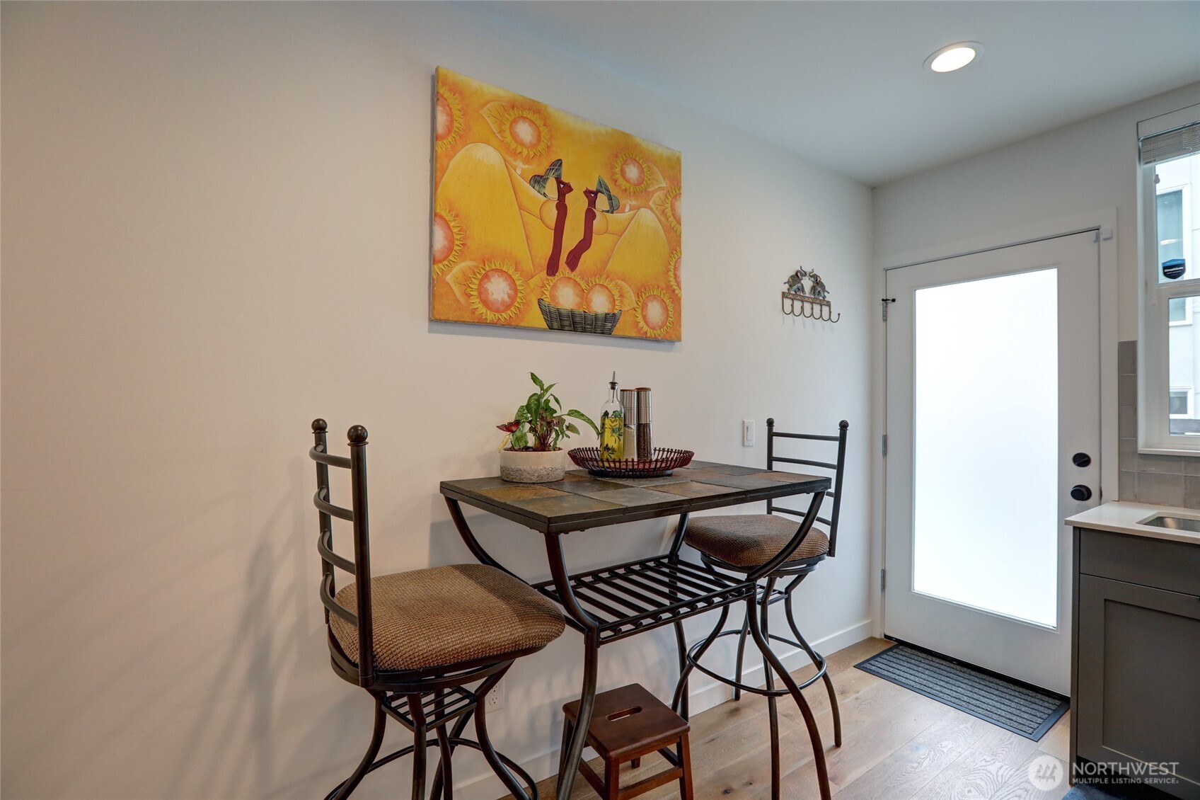 3854 22nd Avenue Southwest Seattle, WA 98106 - Photo 6 of 11 a view of a room that has a table and chair in it