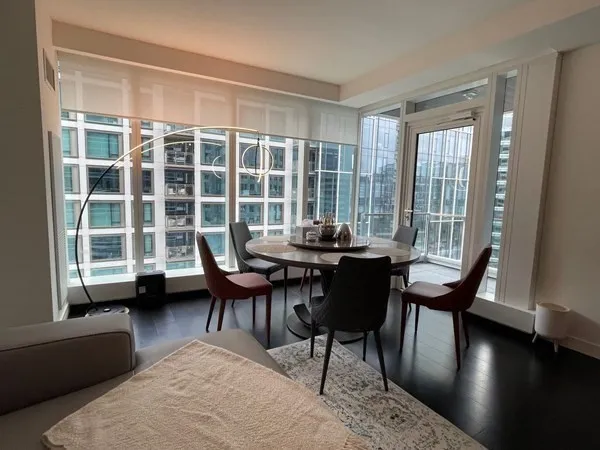 a view of a dining room with furniture and wooden floor