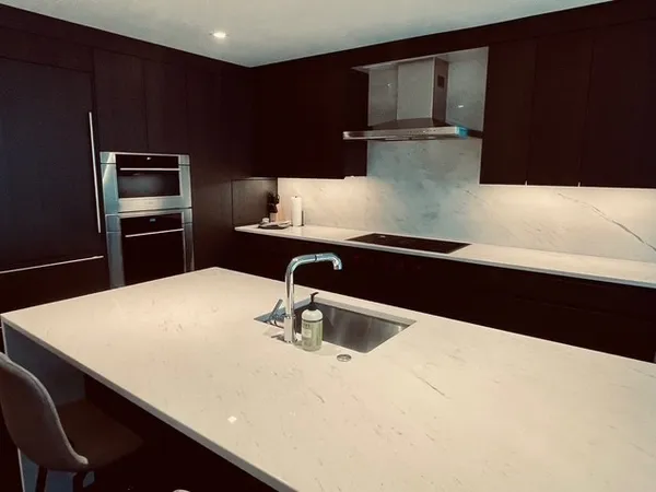 a kitchen with a sink and a refrigerator