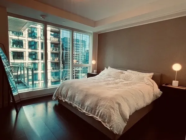 a bed sitting in a bedroom next to a large window